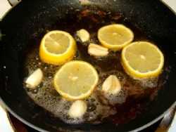 Add lemon and garlic to the drippings