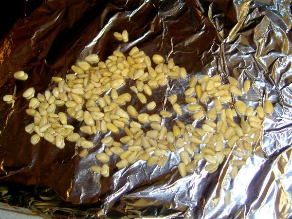 Toast the pine nuts while making the bacon.  Here it is shown on a cookie sheet for the toaster oven