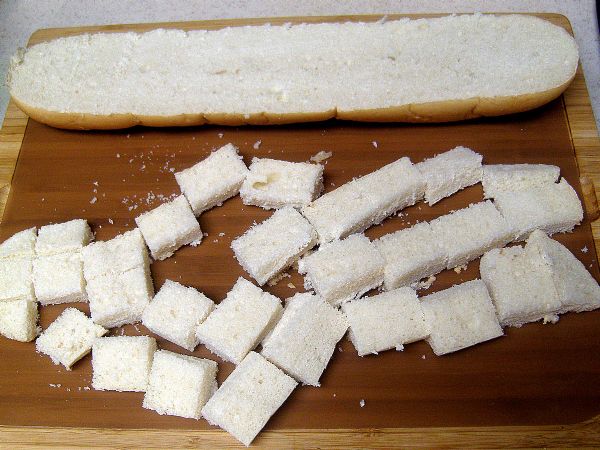 Halve, slice and cube bread.