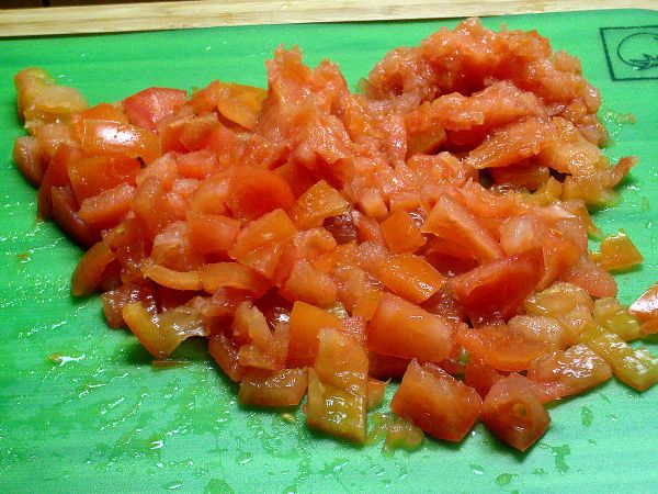 Tomatoes are sliced and deseeded.