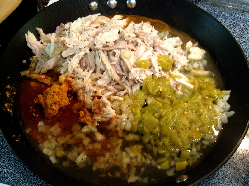 Add chicken, chilies, taco seasoning, water.  Also add salsa - not pictured in this instance. Mix.