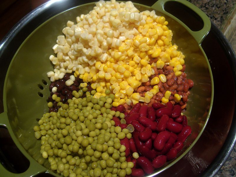 Place beans, peas, and corns into a colander