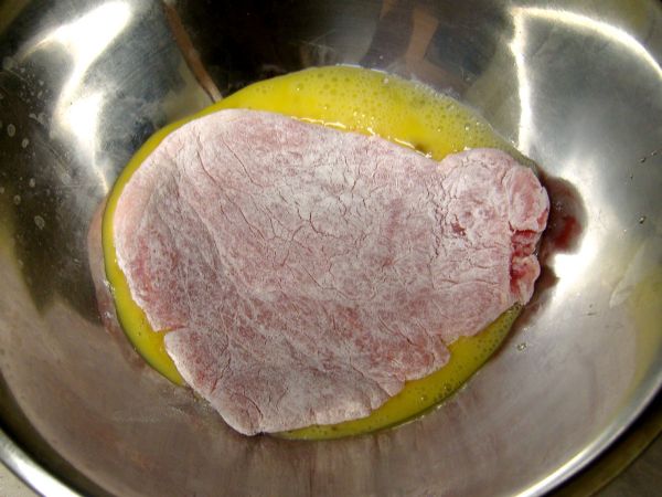 Coat schnitzel with egg (the flour gives the egg some texture to stick to the pork)