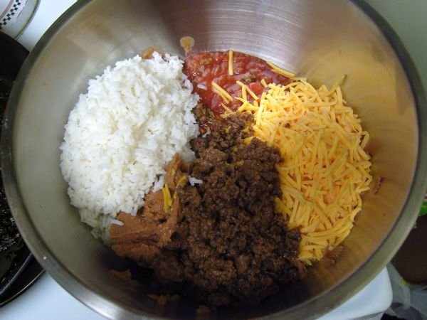 Mix cooked rice, salsa, cheese, beef, refried beans and black beans (omitted in the picture).