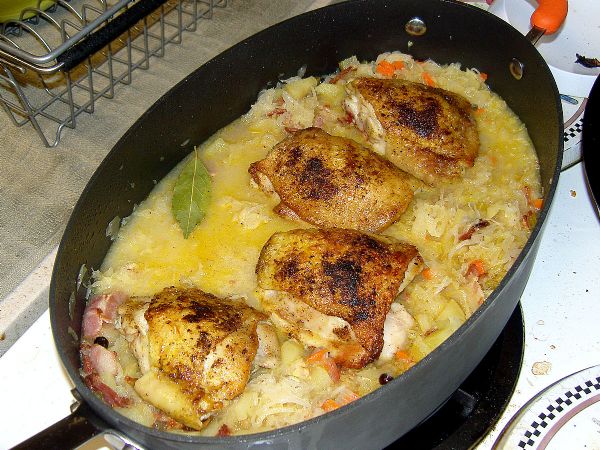 Braising on the bed of sauerkraut, mustard, bay leaf and juniper berries (cover removed for picture)