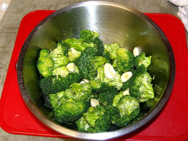 Chop broccoli, toss with oil, add salt, pepper and garlic