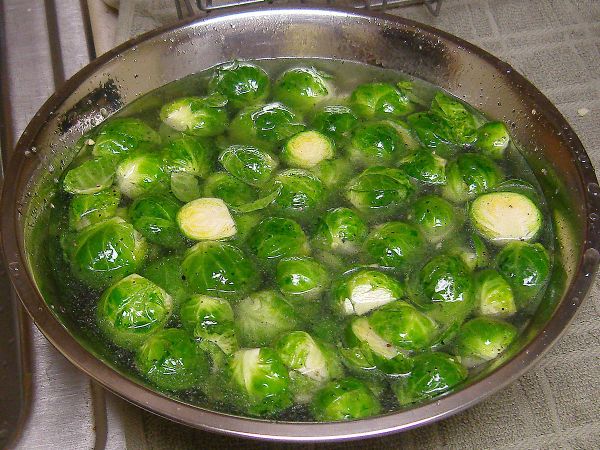 After cutting off the tips and halving the sprouts, soak.  This water has a little bit of oil and so