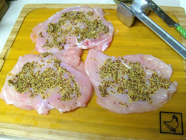 Spread Dijon mustard thinly across underside of chicken