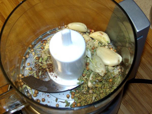 Place spices and garlic in food processor.