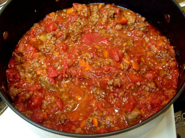 Add meat sauce to tomato sauce and mix. Add salt and pepper.
