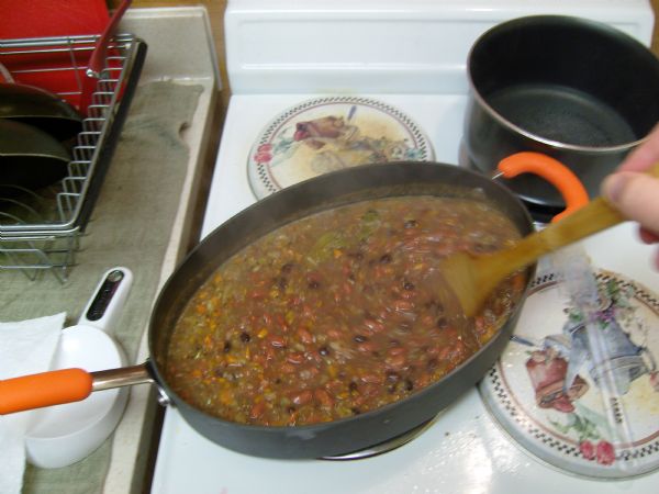 Stirring the beans in (you can see that I used black and red beans for this one)