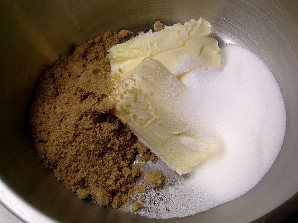 Cream together the sugars with the butter.