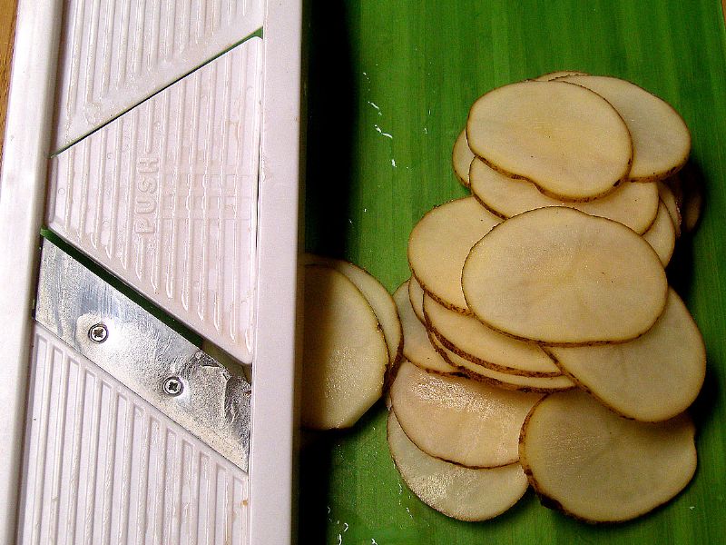 Slice potatoes thinly with mandolin