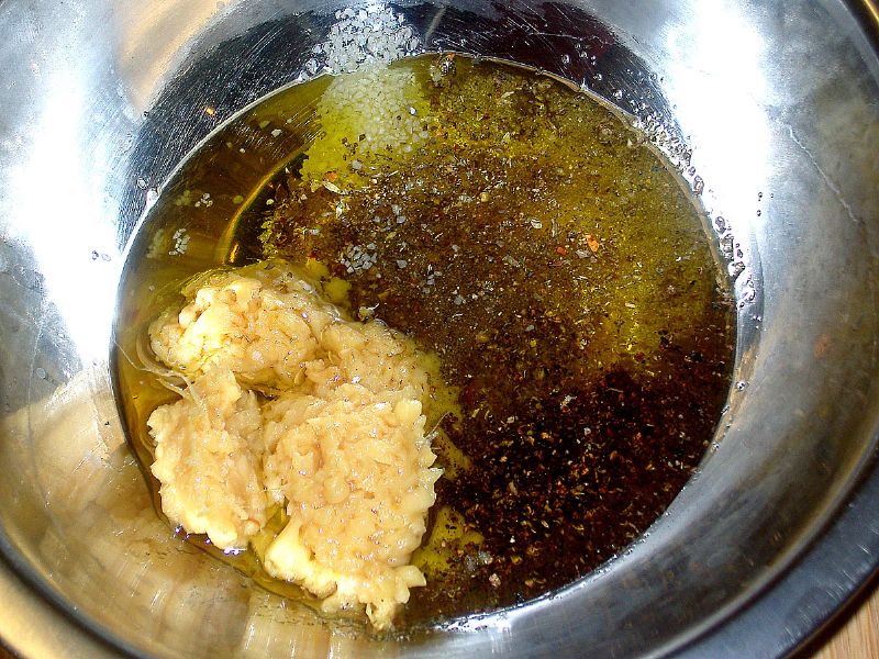 Mix garlic, salt, pepper, basil and oregano in bowl