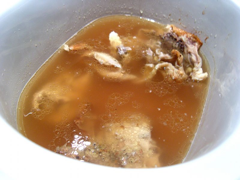 Add chicken to slow cooker with chicken stock.  About 2 hours and the meat will fall off the bone.