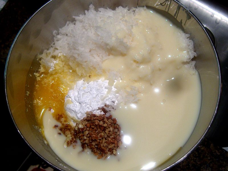 Combine coconut, powdered sugar, melted margarine, pecans, salt and condensed milk.