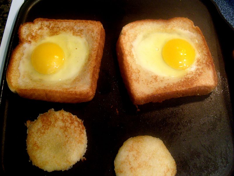 Flip over. Crack eggs into the new holes and cook until the egg whites are hardened.