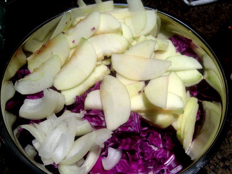Slice onions.  Toss cabbage, apples and onions together.