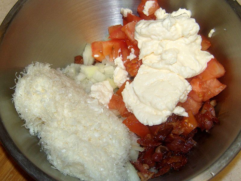 Put bacon, cheese, onion, tomatoes and mayonnaise in mixing bowl.