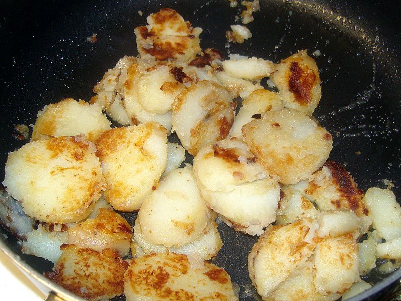 When potatoes are starting to crisp, add the butter.