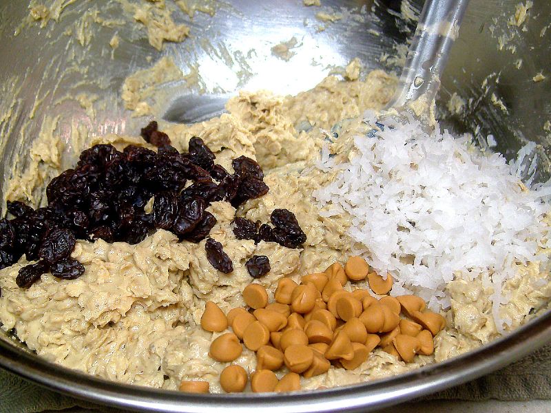 Optional - mix in the raisins, chips and coconut