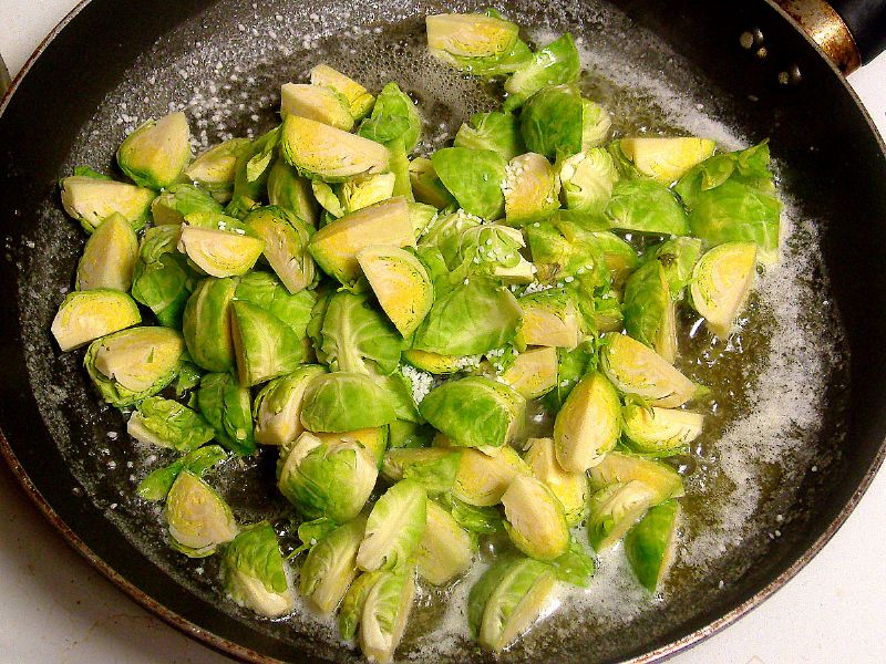 Cleaned, trimmed, quartered - place sprouts and salt in pan