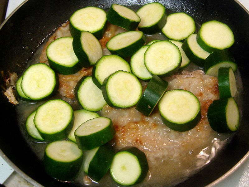 Water and wine added (not shown) and cooked for 15 minutes.  Top the chops with zucchini