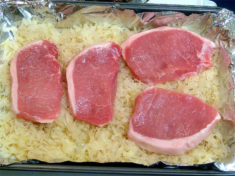 Lightly season chops. Place in pan. Cover with chicken broth (not shown)