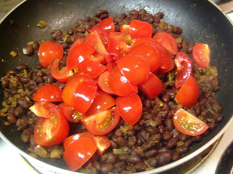 Add tomatoes after the beans are cooked through.