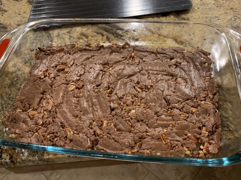 Spread half into the prepared baking dish