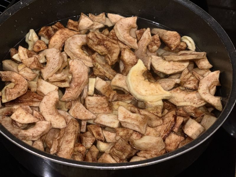 Dehydrated apples in a pot - water almost covering them.